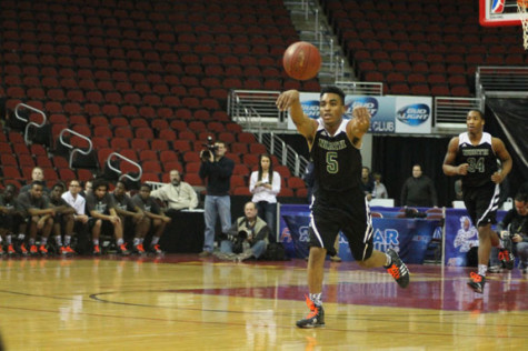 Senior guard Teyontae Jenkins passes the ball down the court against Waukee.