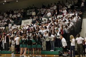 The student section happily joins in the cheer "everywhere we go" as the cheerleaders start it off.