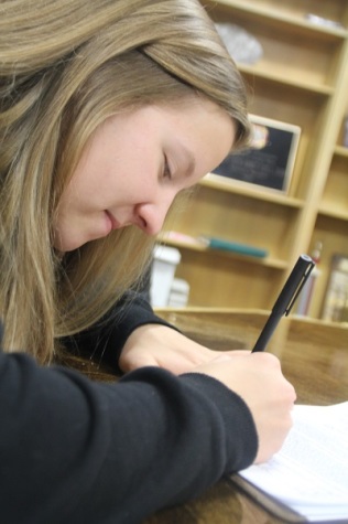 Moriah Ross signing her scholarship