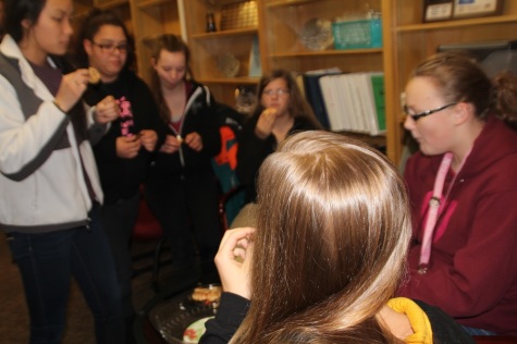 The swim team enjoying cookies and lemonade together, and reminiscing on the year