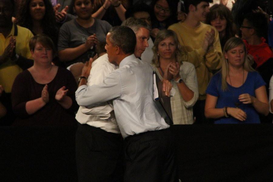 President Obama and Arne Duncan, secretary of education share a hug after they speak to students, staff, and families about college affordability. 
