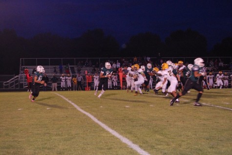 Homecoming Game: Noah Lane, a varsity player is running the ball at the homecoming game North vs. Hoover, September 11, 2015.