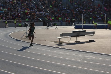 Jaytearia Benson rounds the first corner of the track to start off the event. 