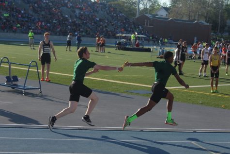 Junior Andrew Phillips hands the baton off to Sophomore Elijah Facey.