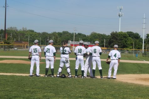 6 of the 9 starters on the varsity team stand, ready to begin the game. 