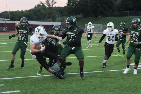 Andrew Phillips is tackled while running up field.