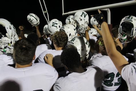 Helmets and crutches are held up after the game.