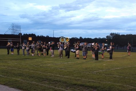 The band plays the national anthem before the game.